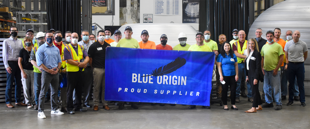 Team Spincraft holding the Blue Origin Proud Supplier Flag